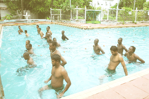 Members and standbys of the Guyana Carib Beer team, with the exception of West Indies middle order batsman, Leon Johnson, going through foot exercises underwater at the Colgrain Pool yesterday afternoon. (Photo by Clairmonte Marcus) 