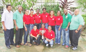 We Have Done It (L-R) Noel Adonis, Charles Graves, Tricia Munroe, Shennel Daniels, Desaun Josiah, Carren Skeete, Grace Jarvis, Shebanne Daniels, Elwin Chase and Troy Yhip.  Kneeling are Carrin Carter, captain Sabola Gray with the trophy and Nekita Davis. (Lawrence Fanfair photo)  