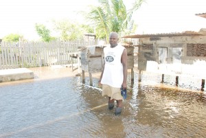 Pastor Brentnol Joseph standing in his flooded backyard at Belfield Housing Scheme yesterday afternoon 
