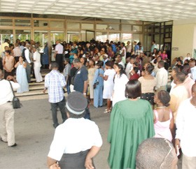 Some invitees to the University of Guyana’s 42nd Convocation were left outside the National Cultural Centre yesterday afternoon because the venue did not have enough seating. A screen was later set up in the foyer which allowed some of them the opportunity of viewing the proceedings. (Photo by Jules Gibson)