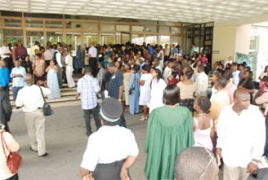 Some invitees to the University of Guyana’s 42nd Convocation were left outside the National Cultural Centre yesterday afternoon because the venue did not have enough seating. A screen was later set up in the foyer which allowed some of them the opportunity of viewing the proceedings. (Photo by Jules Gibson)