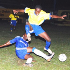 Pele’s Okeniel Fraser skillfully evades a tackle by a Milerock defender. (Lawrence Fanfair photo)