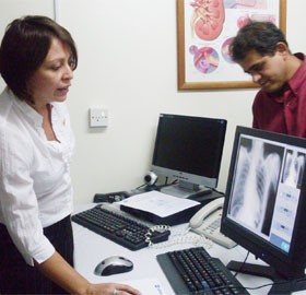 Alicia Barabas (left) demonstrating how radiographers can view x-ray images from a computer in real time using the new Computer Radiographic Unit.