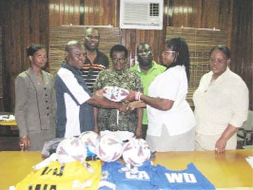 Guyana Netball Association’s (GNA) Maxine Parris (second right) receives a ball from RPSF Liaison officer Troy Peters (second left). Also in photo are Shondell Samaroo, Lawrence “Sparrow” Griffith, Jeanette Lovell, Brian King and Donna Boston.       