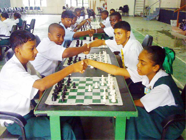 Crystal Khan of Stewartville Secondary School, shakes hands with Mahendra Sahadeo of West Demerara Secondary, at the start of the final round of the 2008 National Schools’ Chess Championship that was held at Queen’s College last weekend. Crystal emerged winner of  the Category B segment of the competition, scoring 8½ points from nine games, and beating the field by 1½ points. William Holder of Queens College placed second on 7 points. This is Table 1 of the Category B section going into the last round. In picture, at the number two spot are Holder of QC and Jason Barnwell of McKenzie High School. At the end of the table in the third spot are Rondel Douglas of QC and Paul Bachan of the New Amsterdam Multilateral. 