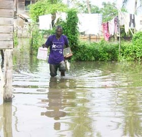Now, where’s the road? A resident of Dochfour walking through the  floodwaters to get to his home yesterday. 