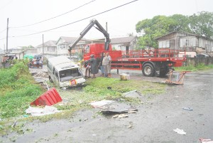 The Route 41 minibus, BJJ 4851, which struck and killed former national footballer Selwyn Bailey early on Christmas morning, as it was extracted from the D’Urban street drain where it came to a rest. (Photo by Lawrence Fanfair) 