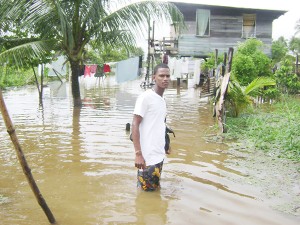 Dochfour resident, Devon Samuel stood in his front yard showing the water that was above his knee.  