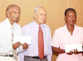From left: Harry Ramsaroop, Head and Treasurer of the Dharm Shala; Chairman of DDL Yesu Persaud; and Wendy Alves, nurse aide at the Cheshire Home.