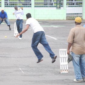 Part of the action in the Dyna’s embroidery/Carib Super 7 tape ball competition at the National Park tarmac yesterday. (A Calvin Roberts photograph) 