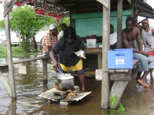 These men were cooking in the floodwaters at Victoria yesterday.  