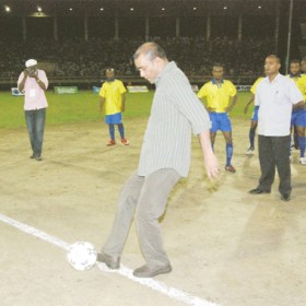 LET’S GET IT ON! President Bharrat Jagdeo kicks the ball to start the final. (Lawrence Fanfair photo)   