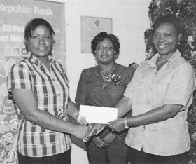 Republic Bank (Guyana) Limited says its Camp Street branch customer Alison Tinnie was the second winner in its ‘Make all your wishes happen this Christmas’ loan campaign. Tinnie was presented with her cash prize of $150,000 at a ceremony hosted on Christmas Eve day. Her name was selected at a prize draw held at the Water Street branch earlier in that week. The Bank said this was the second of three presentations in this promotion and a grand draw will be held at the end of the promotion where a lucky customer will win $1,000,000. In picture a smiling Tinnie (right) collects her prize from Camp Street branch Personal Loans Officer Dulce Thomas while Supervisor, Retail Lending Unit Vanetta Grant looks on. 