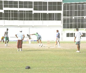 FINALLY! After two days in the pavilion due to rain, the national cricketers were able to get in some much needed turf practice yesterday at the National Stadium at Providence on the eve of their departure  for their first two away matches of the West Indies Cricket Board regional four day competition. In the picture below, Christopher Barnwell sends down a delivery to Shemroy Barrington as from left, Brendon Bess, Zaheer Mohammed, Krishna Arjune (non-striker) and coach Albert Smith look on.  (Clairmonte Marcus photo)