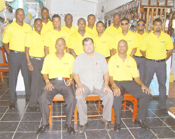 The Guyana team minus wicket-keeper Darwin Christian, prior to its departure for the  Cheddi Jagan International Airport (CJIA) yesterday. President of the Guyana Cricket Board (GCB) Chetram Singh, sitting, is flanked by Carl Moore, left and Albert Smith. (A Lawrence Fanfair photograph) 