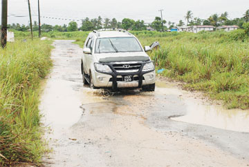 This vehicle tries to manoeuvre around the potholes on the Great Diamond road.  