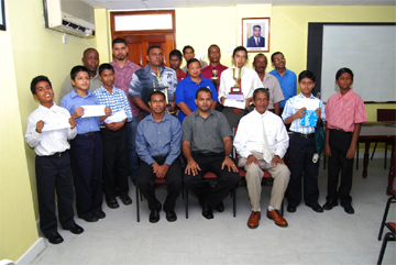 The 2008 national Chess championships winners with Minister of Culture, Youth and Sports Dr. Frank Anthony, centre, president of the Guyana Chess Federation, Errol Tiwari, right, and tournament director Irshad Mohammed, left. (Lawrence Fanfair photo) 