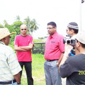 Newly-appointed Minister of Housing and Water, Mohamed Irfaan Ali (centre), during a visit to Tuschen, East Bank Essequibo on Sunday. He had visited to take a first-hand look at the Tuschen Well station, which recently encountered problems. It was decided that water will be delivered to affected residents in trucks. At left, facing the Minister is Chief Executive Officer of Guyana Water Incorporated, Karan Singh.