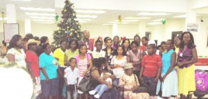 Phillip Freeman (at centre, back) poses with employees and the families who benefitted from the hampers 