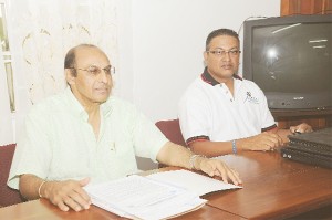 President of the Guyana Olympic Association (GOA) K. A. Juman Yassin sits at  left with president of the Guyana Badminton Association (GBA) Gokarn Ramdhani (right) at a press briefing yesterday in the GOA’s boardroom. 