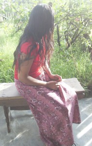 Ann Rosita Boodhoo, 22, sits on bench at the place where she now calls home and where she feels safe.  