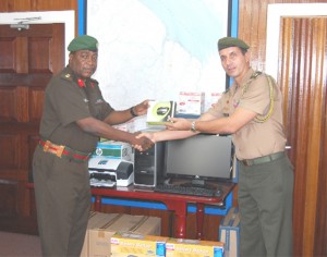 Colonel General Staff of the GDF, Colonel Mark Phillips (left) receiving the equipment from  Colonel Eudes Carvalho Dos Santos (GDF photo) 