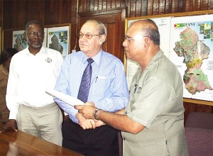 Acting Vice-Chancellor of the University of Guyana, Tota Mangar (second from right) with Chairman of the Guyana Geology and Mines Commission (GGMC) Board, Ronald Webster after the signing of a Memorandum of Understanding between the two entities for scholarships. Looking on, at left, is Commissioner of the GGMC, William Woolford. 