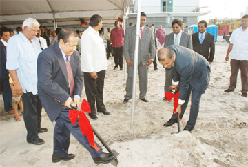 NBS CEO Ahmad Khan (left) and President Bharrat Jagdeo (right) turning the sod, while government officials look on. 