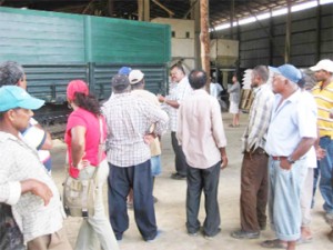 Rice miller Dindial Joree (centre) speaking to some of the farmers   