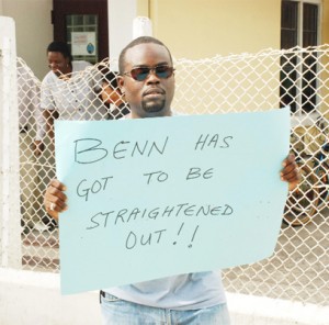 An air traffic controller sends a message to Minister of Transport and Hydraulics Robeson Benn during a protest outside the minister’s office yesterday. 