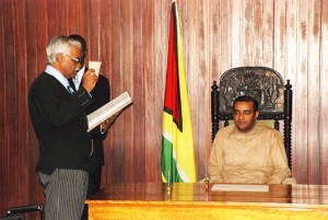 Charles Ramson takes the oath of office in the presence of President Bharrat Jagdeo at the Office of the President yesterday. (Jules Gibson photo)