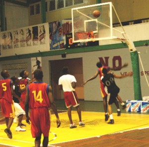  Part of the action between Bishops’ High School and Charlestown Secondary at the Cliff Anderson Sports Hall on Monday. (Aubrey Crawford photo)          