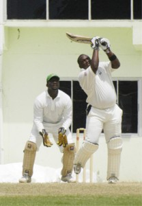 Going, going, gone! Jamaica’s captain Tamar Lambert hits Narsingh Deonarine over long off for six during  the first day of the Jamaica/ Guyana sixth round clash at the Guyana National Stadium, Providence yesterday. Wicket-keeper Darwin Christian looks on. (Aubrey Crawford photo) 
