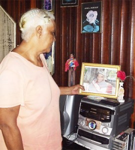 Norma Valentine looks at a photo of her late husband Irving Ferreira at her home recently. 