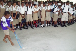 One of the participants at the session, displaying his dribbling techniques, whilst fellow students look on admiringly.   