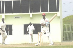  Trinidad and Tobago’s in-form opener Lendl Simmons pulls a delivery from fast bowler Trevon Garraway (second right) during his unbeaten 148 yesterday at the Guyana National stadium, Providence. (Aubrey Crawford photograph)   