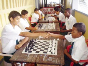 Two West Demerara Secondary School students observe the traditional handshake before beginning their game at the school’s Mashramani tournament. School teacher Vishnu Rampersaud is conducting a round robin inter-house chess tournament for students of the West Demerara Secondary. There are 23 participants, and the leaders of the tournament are Meikel Mohabir, Emanuel Ambadkar, Mahendra Sahadeo and George Jeffers. The students are using the chess sets which were donated to the school recently by the Ministry of Culture, Youth and Sport.   