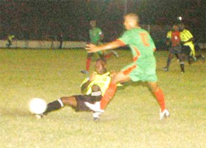 Mayor’s Cup Action! This Milerock player slides and makes a clean tackle in the game against GDF on Friday at the GFC ground. GDF went on to defeat Milerock 2 – 1 to enter the quarter-finals of the competition. (Aubrey Crawford photo)  