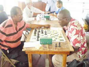 David Khan and Kenrick Braithwaite concentrate on their game last Sunday at the beginning of the Topco Juice Mashramani tournament hosted by the Guyana Chess Federation. The tournament is sponsored exclusively by Demerara Distillers Limited under the Topco Juice brand. At the end of three rounds, National champion Kriskal Persaud is leading among the seniors and Khalid Gajraj among the juniors. The remaining four rounds to conclude the tournament will be played on Sunday, March 1. 