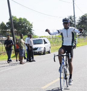 In this Clairmonte Marcus photograph, Darren Allen crosses the finish line unchallenged in the PNCR/NSC-organized Forbes Burnham memorial cycle road race yesterday.  