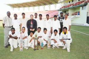 The victorious Corentyne under-15 team strikes a pose with acting president of the Guyana Cricket Board (GCB) Bissoondial Singh (standing fourth from left), along with coach Karl Vanier Jnr and manager Mark Lyte (standing right and left respectively). (Clairmonte Marcus photograph) 