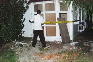 A Police rank cordoning the ground floor windows through which George Codogan’s attackers appeared to have gained entry to his house. 