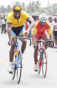 Warren “40” McKay out sprints Robin Persaud to take the checkered flag and win this year’s BK International/Cheddi Jagan Memorial road race. (Clairmonte Marcus photo)