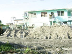 These piles of sandy clay mixed with stones were thrown from the well yesterday.  