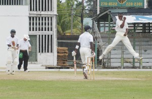 It’s celebration time for Christopher Barnwell (airborne), after he had Kyle Corbin (backing camera) caught by Travis Dowlin at slip. The non-striker is Nikolai Parris. (Aubrey Crawford photo)   