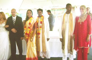 Staff members of the Roraima Group pose in traditional Christian, Hindu and Muslim ceremonial wedding garments.  