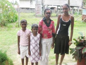  Hemwattie (second left) with burns to her face poses with her sisters, Sookdai (left) and Basmattie and Kumarie (right). 