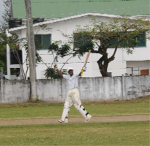 Troy Nurse celebrates his century yesterday. Nurse scored 108 for the Demerara Cricket Club against Transport Sports Club at DCC in Queenstown. (Clairmonte Marcus photo)    