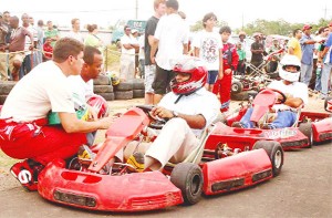 This is what you have to do! Guyana’s champion race car driver Mark Vieira is seen in this Orlando Charles photograph explaining to Minister of Culture, Youth and Sports, Dr Frank Anthony what he has to do before he takes the track. 