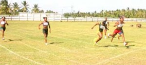 Tiffany Carto (2nd from R) crosses the finish line first ahead of Ruralites Deja Smart (3rd from L) and fellow club mate Maliyka Francois (R) in the National Youth/Junior championship yesterday at the Enmore Sports Club ground. (Orlando Charles Photo)   